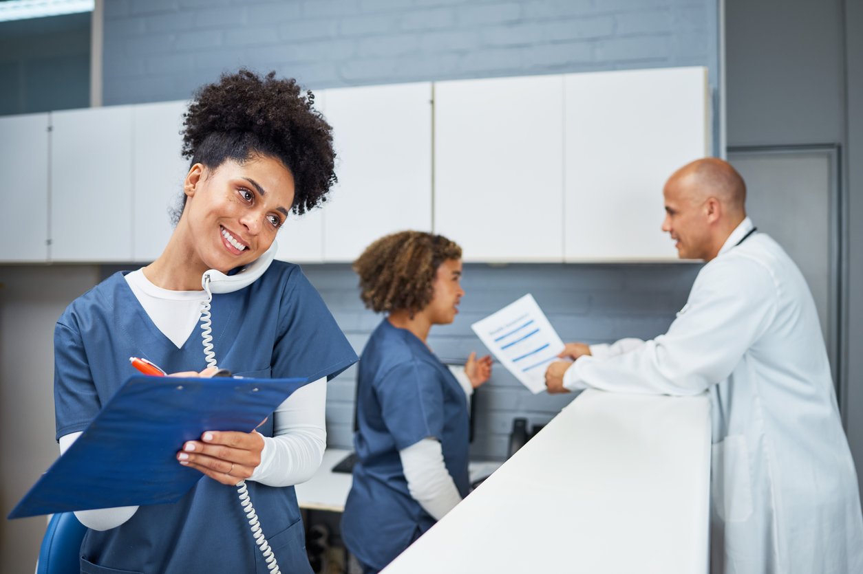 Medical admin on phone while taking notes
