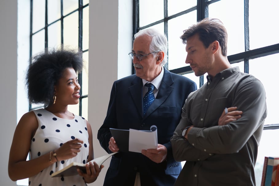 3 people interacting together in professional environment