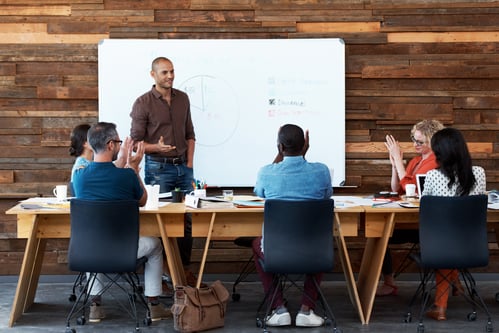 Group of coworkers at table during a presentation