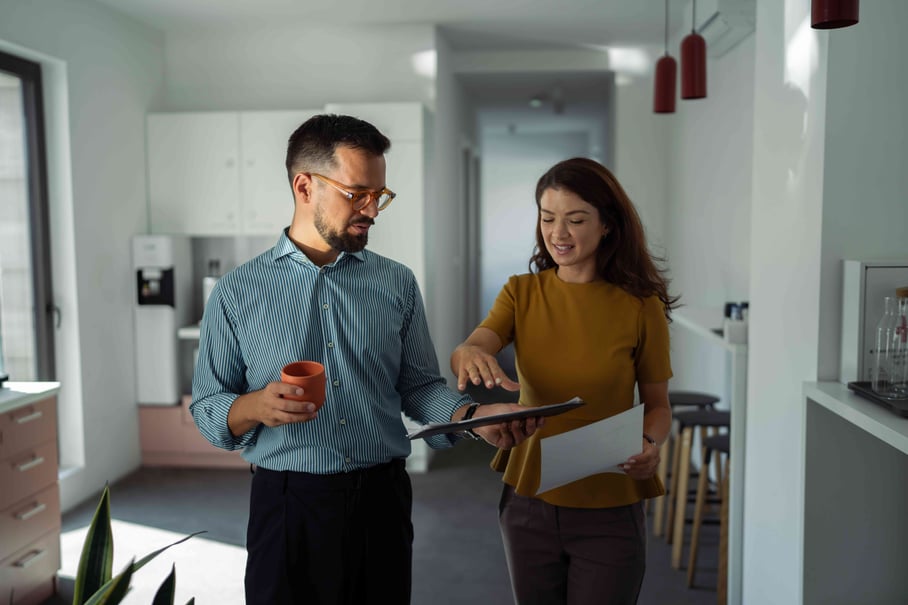 Colleagues discussing document in break room