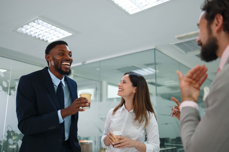 Three coworkers chatting during a coffee break