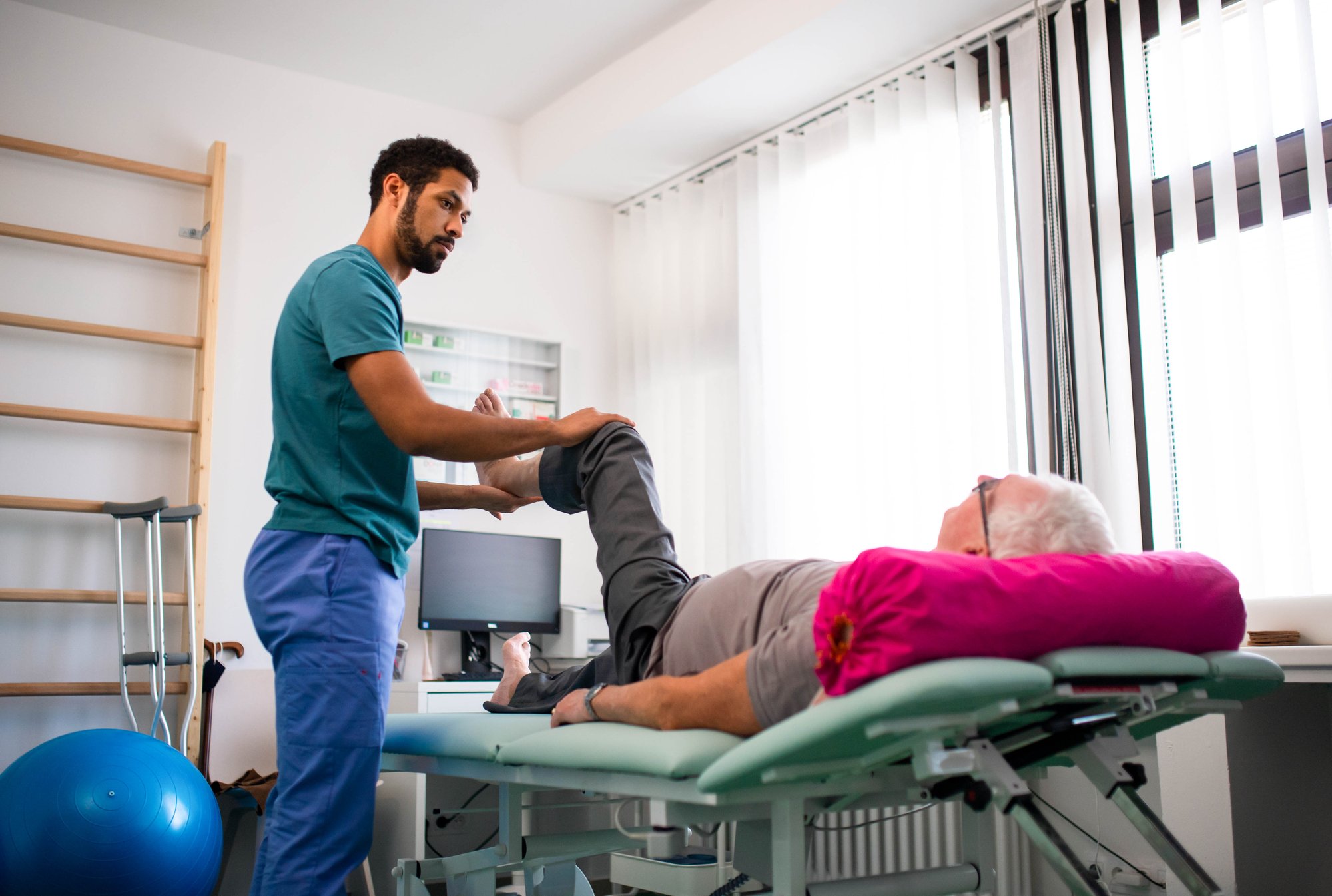 Older man receiving physical therapy