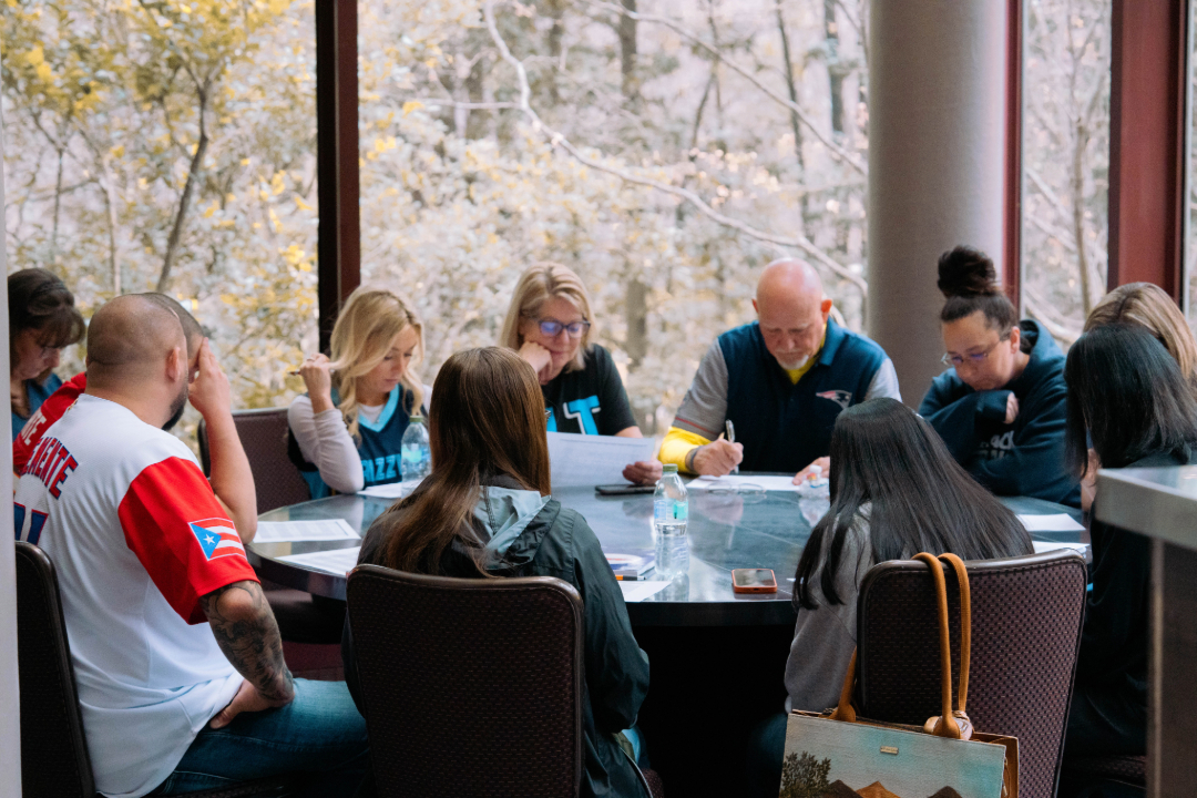 Group of coworkers reading together at a table