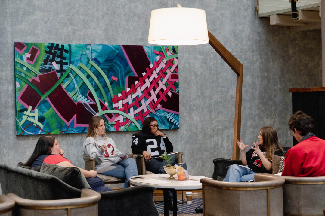 Small group of coworkers sitting in hotel lounge talking