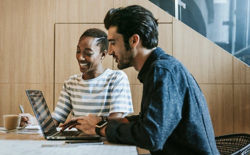 Two colleagues working together at a desk