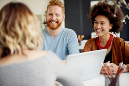 3 people smiling together in work environment