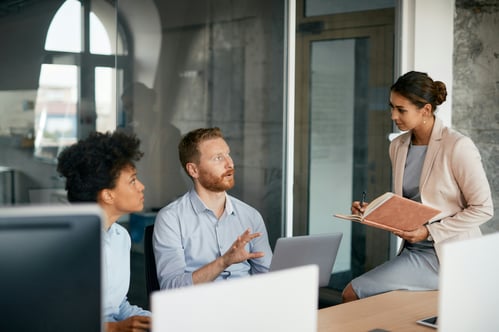 Three coworkers sitting in an office working together