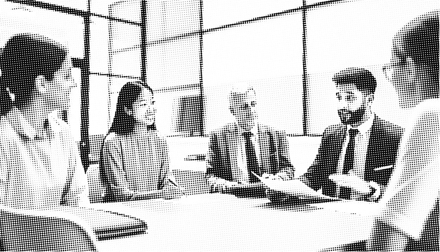 modern office workers sitting at a table collaborating